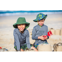 two kids wearing the Khaki Swim Hat building sandcastles at the beach
    		