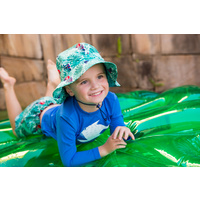 boy smiling on floatie wearing the Parrot Hat
    		